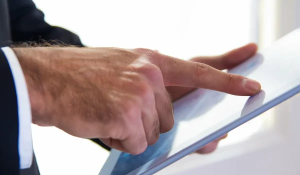 hand-s-detail-businessman-using-digital-tablet